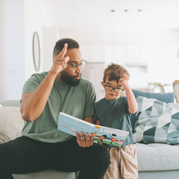 A human using sign language to read to a child.
